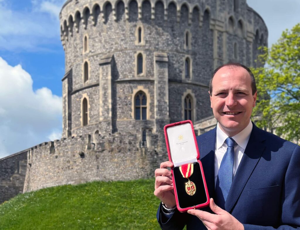 Ian Chapman at Windsor castle holding his honour.