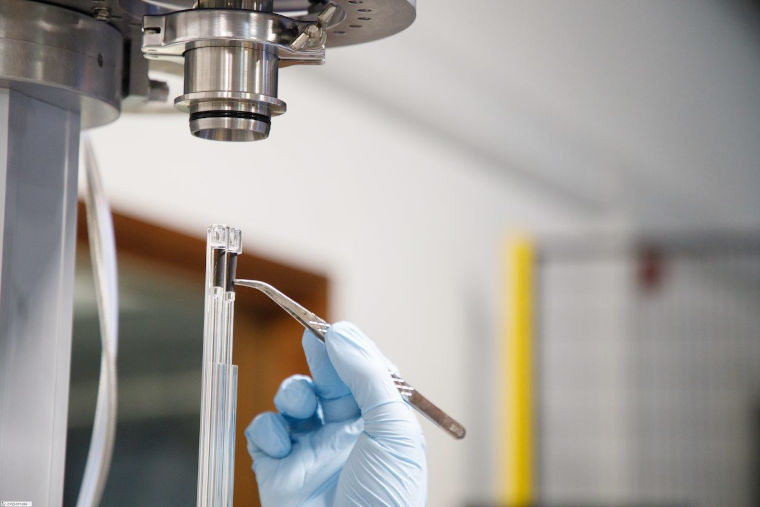 A close up of a scientist working with a carbon reference sample.