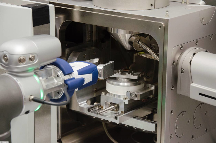 close up of a robotic arm loading a sample