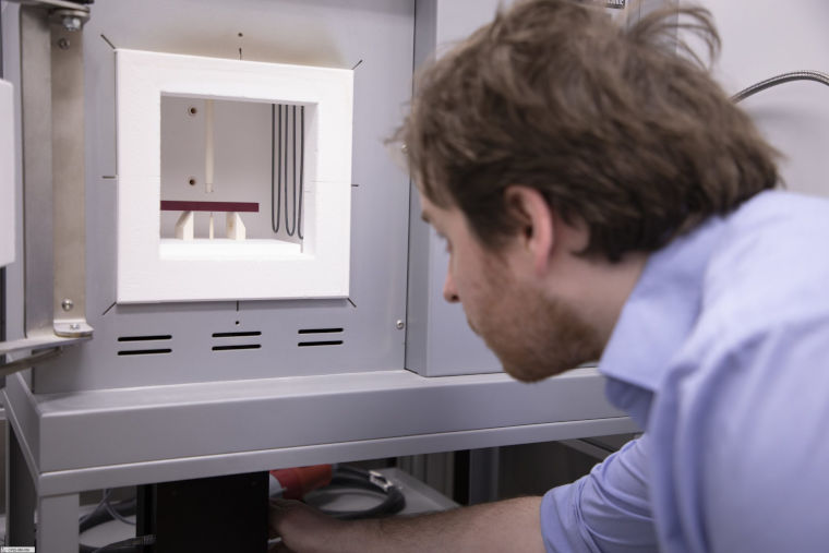 A scientist carrying out an experiment with the IET furnace.