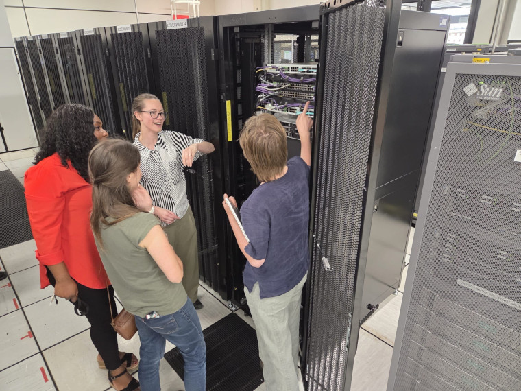 4 women working on computer equipment used in fusion energy research.