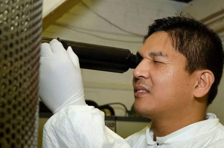 A scientist carrying out an electron-beam experiment.