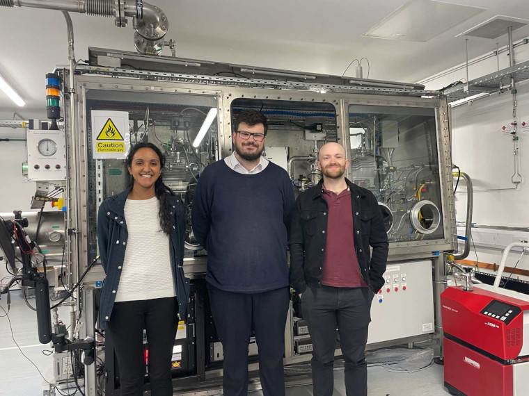 Three members of the DELPHI project in front of the DELPHI equipment.