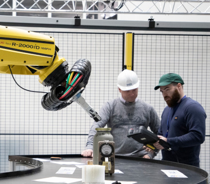 Experts operating a robotic arm.