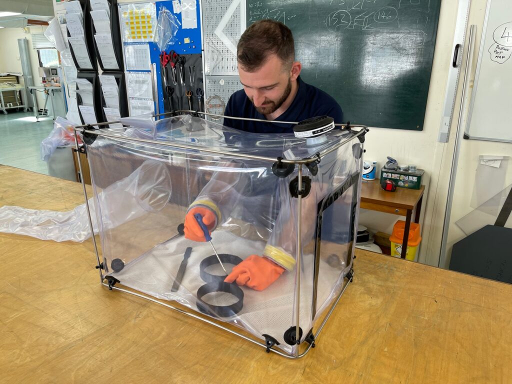 An expert working within the plastic fabrication workshop.
