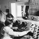 Researchers at UKAEA start the ZETA experiment in front of a control panel.