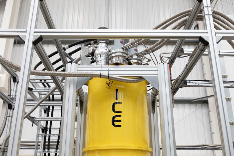 The ELSA testing facility with a large metal frame and a yellow cylinder with ICE written on it.