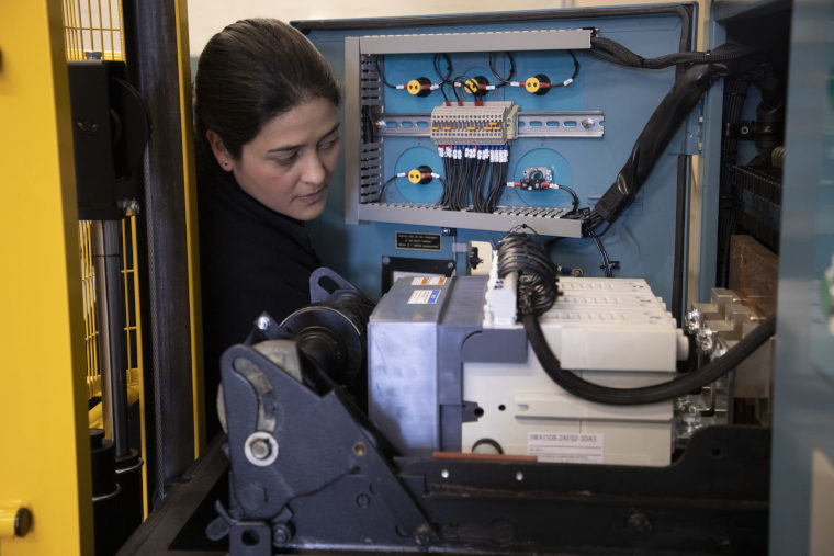 A UKAEA engineering expert works on a machine.