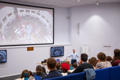 Students at a Culham Plasma Physics Summer School lecture at Culham Campus with an expert lecturer.