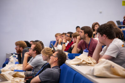 Thoughtful students working out problems in a lecture theatre at the Culham Plasma Physics Summer School.