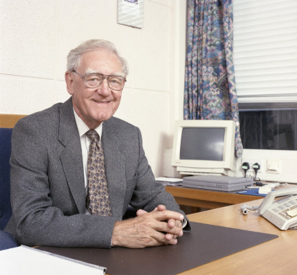 Dr John Bryan Taylor working at his desk.