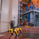 Spot, the robotic dog, returning after autonomous inspection of a fusion energy machine.