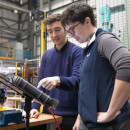 Two expert engineers discussing a fusion engineering experiment at the UK Atomic Energy Authority.