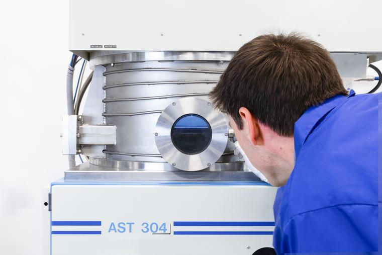 An expert looking through a specialist viewport solving manufacturing problems at UK Atomic Energy Authority.