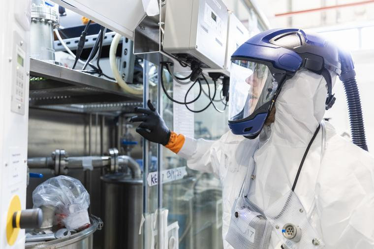 An expert, wearing protective equipment, working at the UK Atomic Energy Authority's Materials Detritiation Facility.