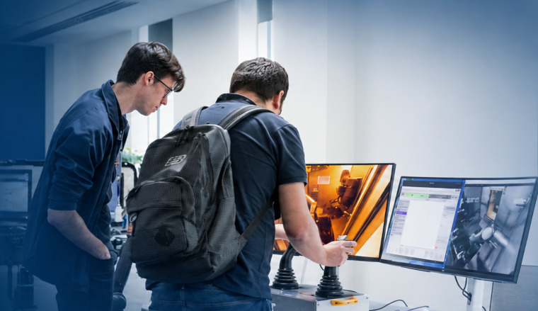 Industry experts looking at screens together at a suppliers event at the UK Atomic Energy Authority.